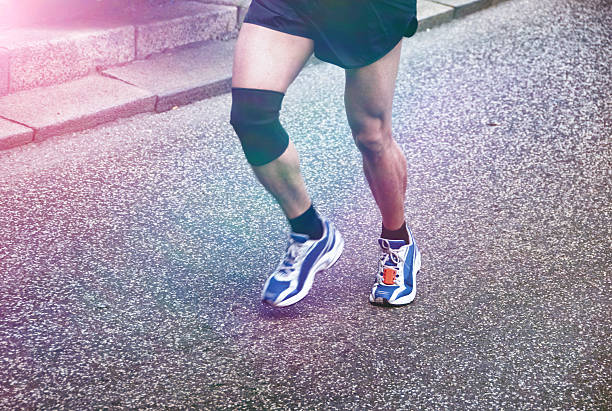 istock Runner with injured knee participate in run 476204520