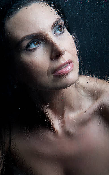 istock Woman the window in the rain 476205082