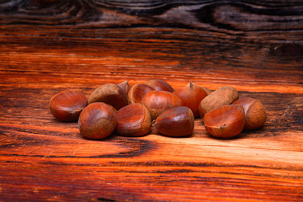 istock Chestnuts on wooden background 476208768