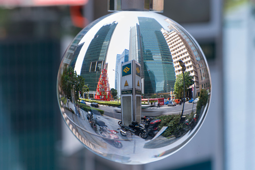 Singapore, Singapore - May 26, 2015: Reflection of skyscrapers in Central Business District of Singapore during daytime, showing busy vehicle traffic.