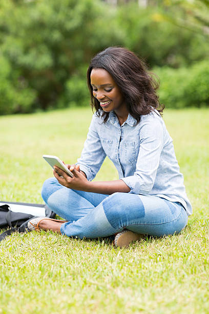 istock female african american college student using mobile phone 476209894
