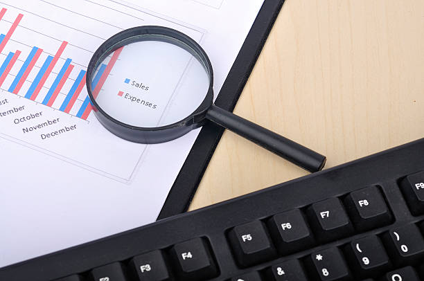 istock Magnifying Glass With Yearly Graph Bar Representing 