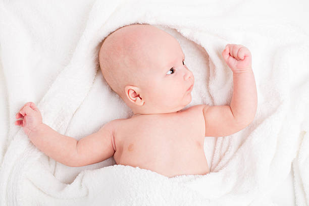 istock Cute baby wrapped into towels 476210221