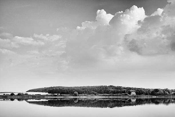 Calm lake in late summer, grain added, BW