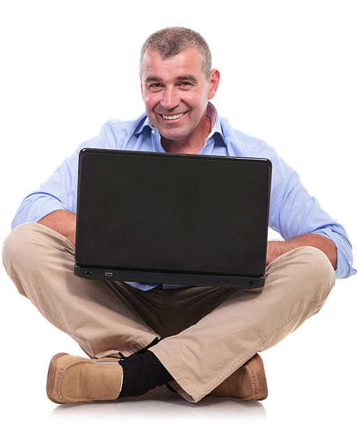 istock casual old man sits and works at laptop 476212189
