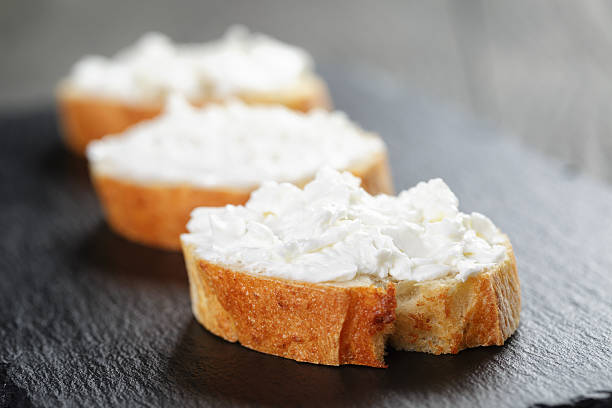 istock crunchy baguette slices with cream cheese on slate board 476213010