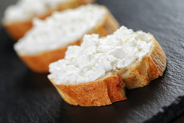 istock crunchy baguette slices with cream cheese on slate board 476213510