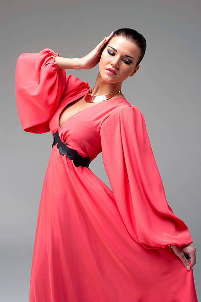 istock girl in a long red dress dancing 476218021