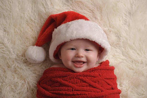 istock Happy Swaddled Baby Wearing Santa Hat 476219077