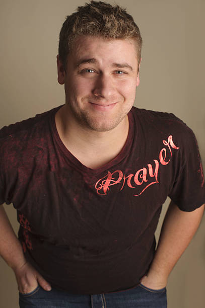 istock Smiling Man Wearing Christian Shirt With Hands in Pockets 476219145