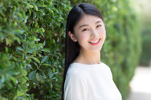 beautiful asian girl, spring green bokeh background.