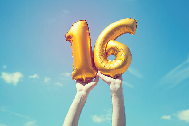 Gold number 16 balloon stock photo