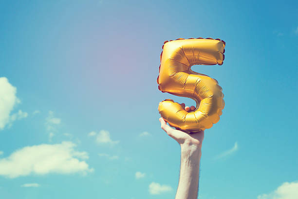 Gold number 5 balloon stock photo