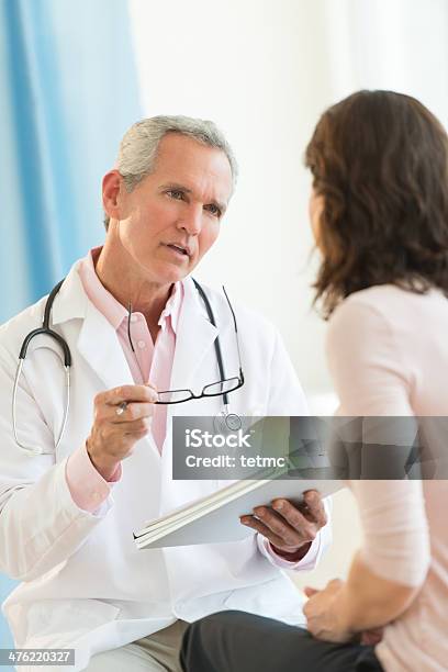 Doctor Communicating With Female Patient Stock Photo - Download Image Now - Patient, Discussion, Doctor