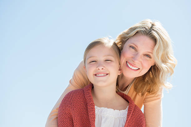istock Happy Daughter And Mother Against Clear Blue Sky 476220557