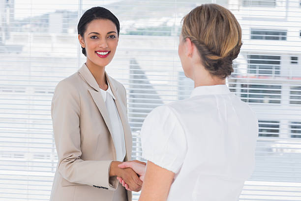 istock Cheerful business partners shaking hands 476221181