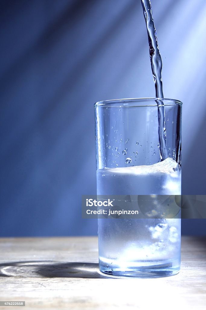 Glass of cold water Photo of a Glass of cold water on a wooden, table 2015 Stock Photo Glass of cold water Photo of a Glass of cold water on a wooden, table 2015 Stock Photo