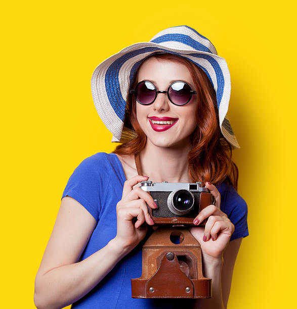 istock girl in blue dress with camera 476227084