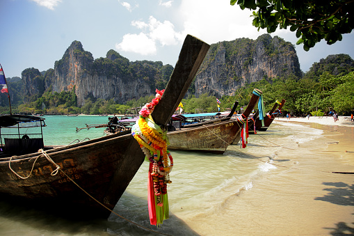 Krabi, Thailand - April 21, 2015: Row of longtail boats anchored to the shore in Railay Beach, Krabi Province.