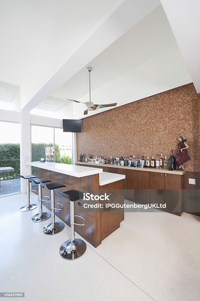 Bar Counter And Bottles With High Ceiling Bar counter and bottles with high white ceiling Bar Counter Stock Photo