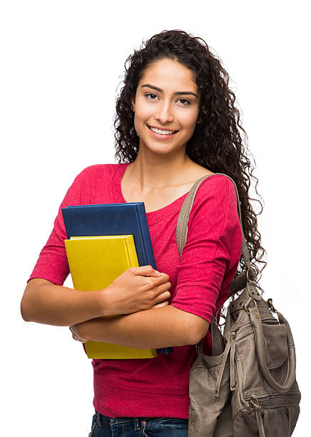 Close-up of female college student Close-up of a female college student standing and smiling isolated over white background three quarter length photos stock pictures, royalty-free photos & images