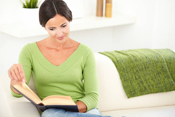 istock Beautiful lady peacefully reading a book 476229434