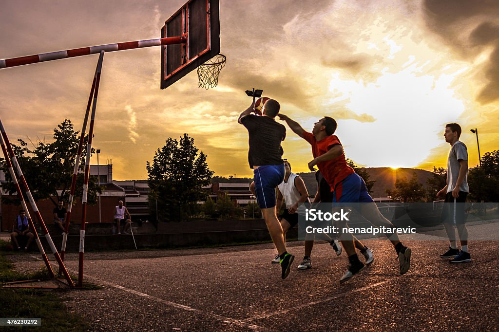 Street basketball at sunset Basketball - Sport Stock Photo