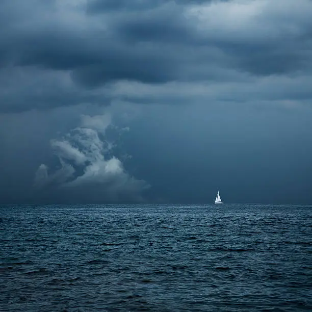 Photo of Boat Sailing in Center of Storm Formation