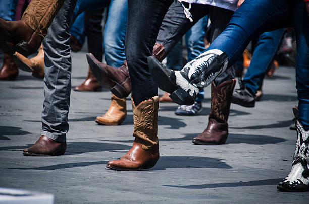 Cowboy Boots Line dancing photo just of the boots in an urban setting. boot stock pictures, royalty-free photos & images