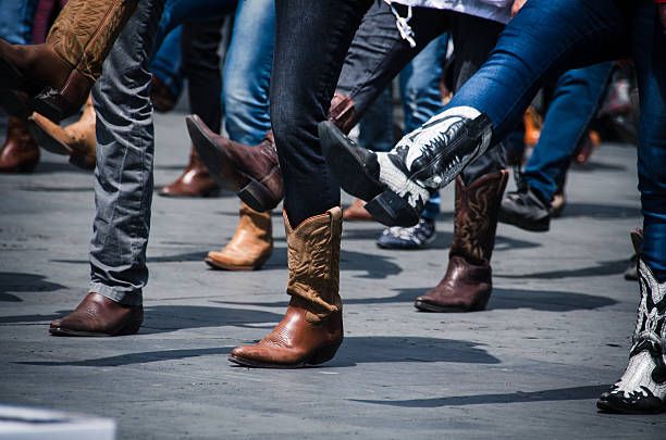 Cowboy Boots Line dancing photo just of the boots in an urban setting. Cowboy stock pictures, royalty-free photos & images