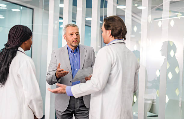 istock Businessman talking with two doctors about new reports. 476232914