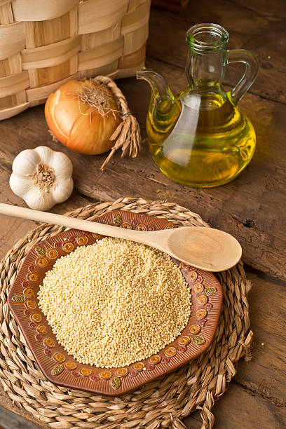 miglio e olio d'oliva rustico sfondo - cooking oil olive oil nutritional supplement spoon foto e immagini stock