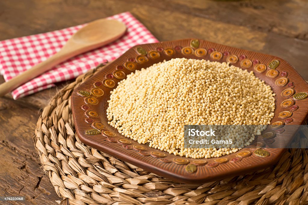 Peeled millet from organic farming Peeled millet from organic farming on rustic background 2015 Stock Photo