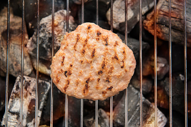 istock Hamburgers on Grill with Dancing Flames Cooked 476234348