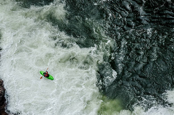 istock Green Kayak in White Water 476237628