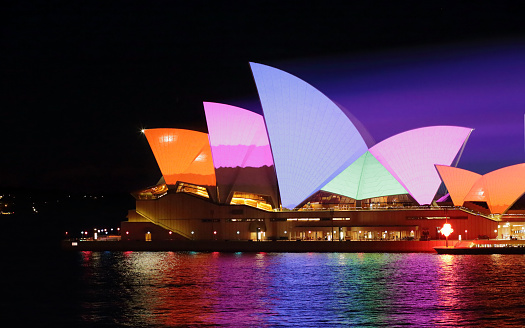 Sydney, Australia - June 2, 2015:  Sydney Opera House in bold dynamic colourful patterns for Vivid Sydney annual festival event. Prominant colours of orange pink, blue and green