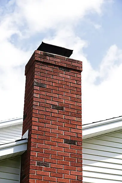 Photo of Red Brick Chimney and Puffy Cloud Sky