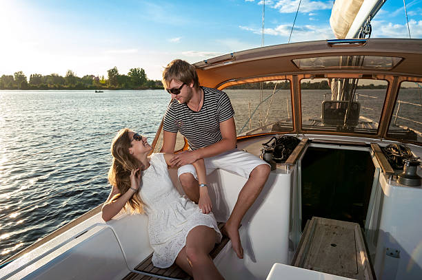 istock Happy young couple relaxing on a yacht 476243731