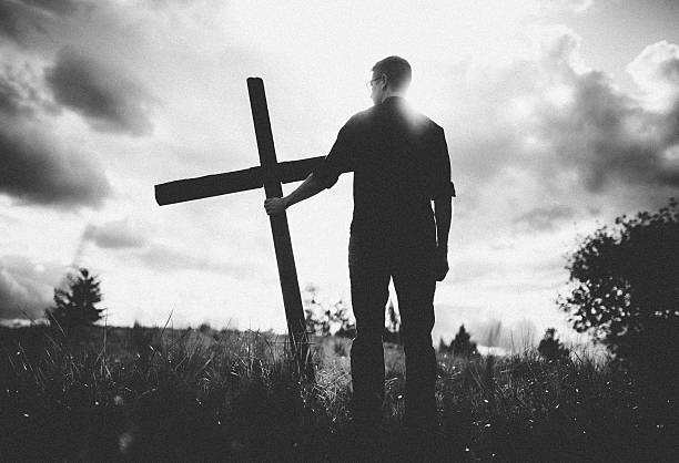 istock Man Carrying Cross of Christ on His Shoulder 476244600