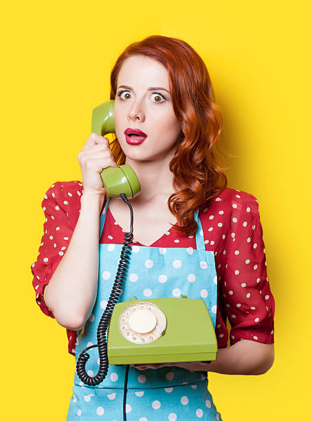 istock girl in red dress with green dial phone 476244708