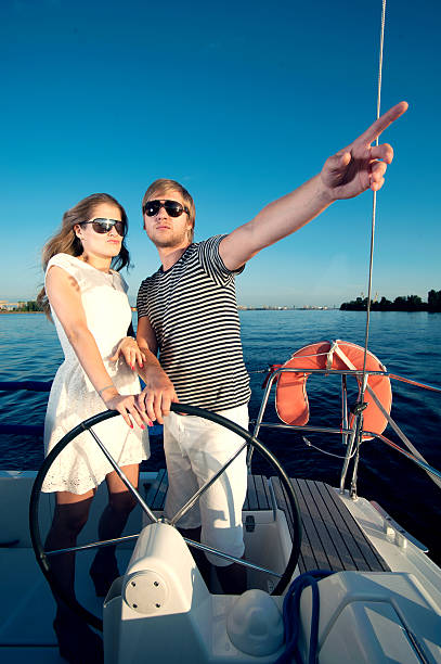 istock Happy young couple relaxing on a yacht 476246621