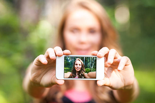 istock Young woman holding smart phone 476246705