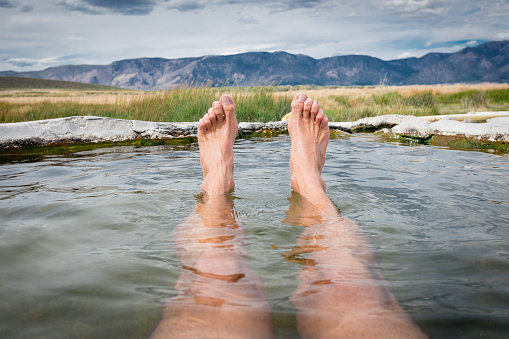 Relaxing in a natural hot spring with a beautiful view.