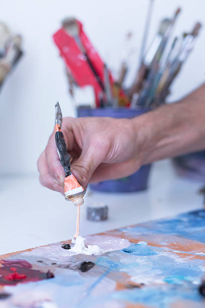 istock male hand adding paint - painting session 476248274