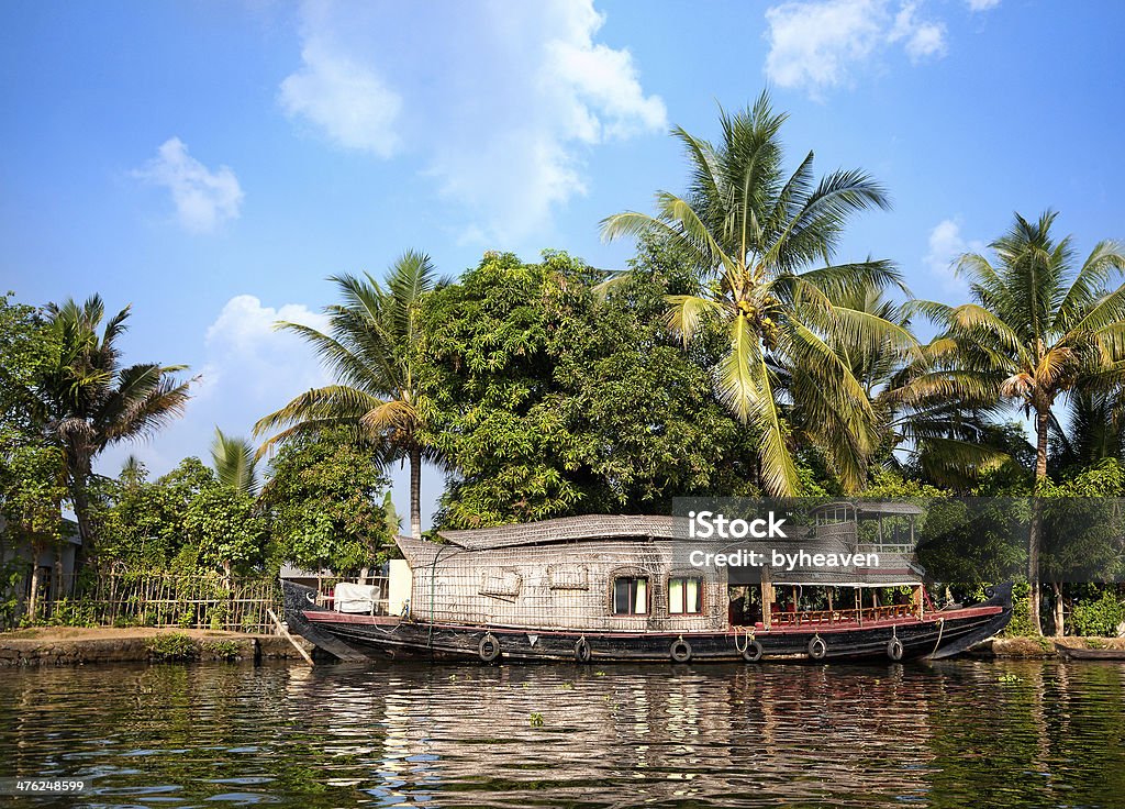 House boat in backwaters House boat in backwaters at palms background In alappuzha, Kerala, India Alappuzha Stock Photo