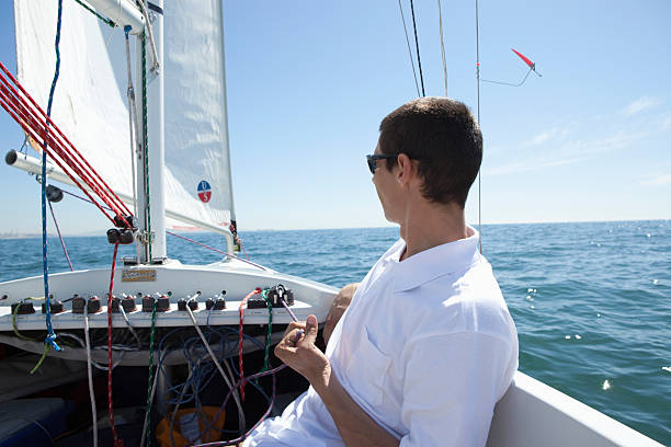 istock Young Man Sailing On Sailboat 476249347