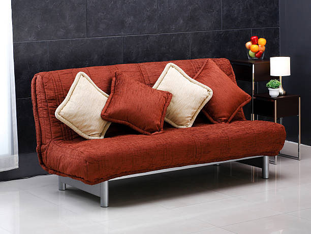 sofa bed and cute cushions A luxury comfortable sofa bed and cute cushions sofa bed stock pictures, royalty-free photos & images