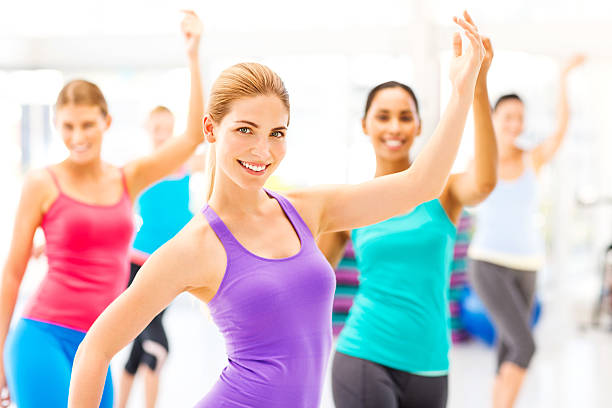 istock Instructor With Female Customers Practicing Dance Fitness In Gym 476250157