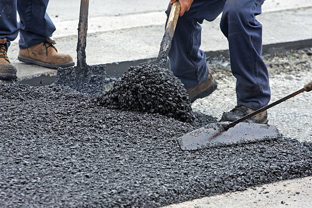 istock Shovelling And Raking Hot Asphalt On A Road Repair Site 476251428