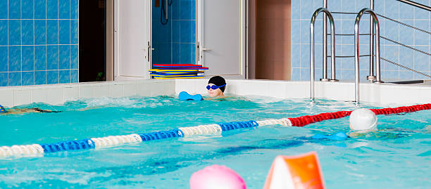 istock The boy who learns to swim in the pool 476251938